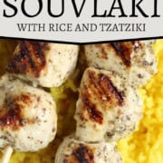 chicken kabobs on top of yellow rice.