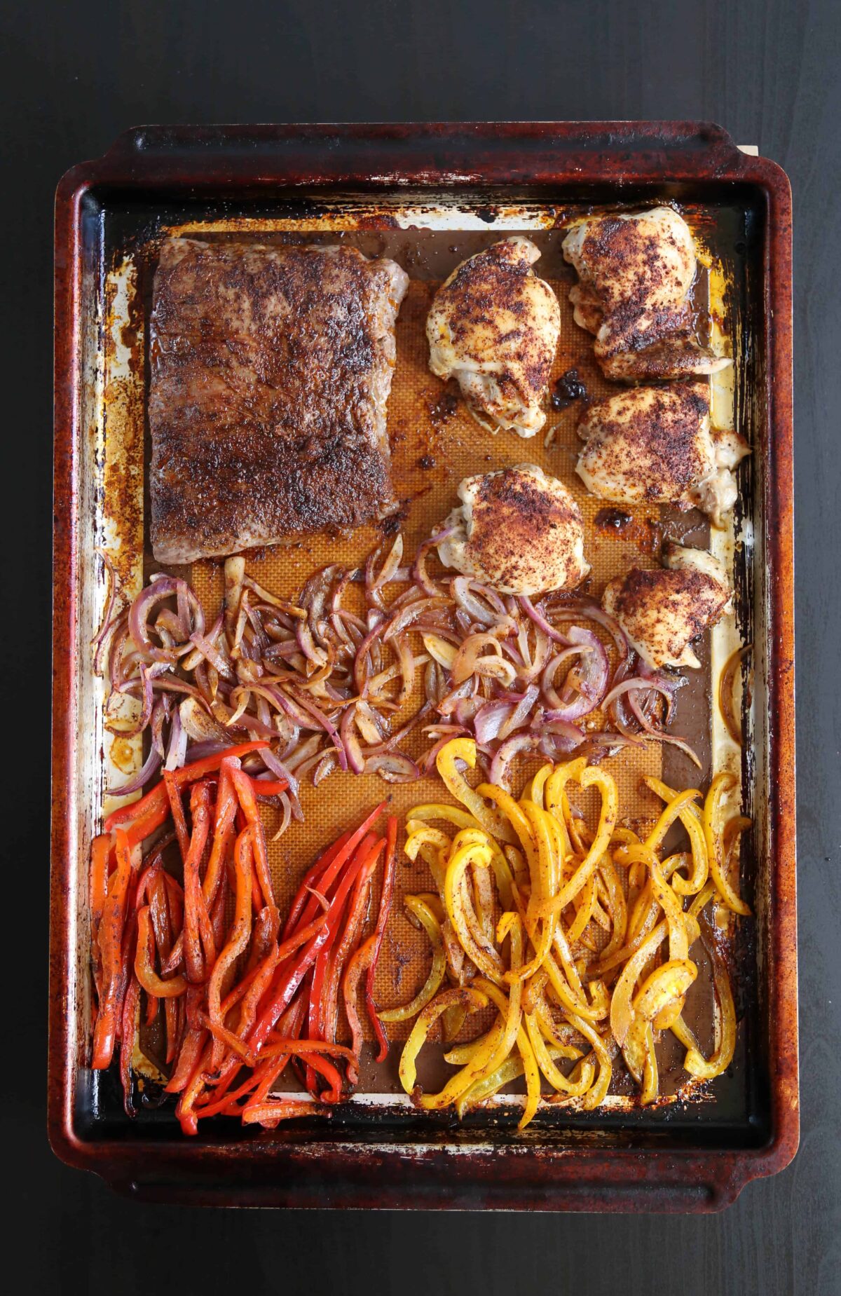 cooked meat and veggies on a sheet pan