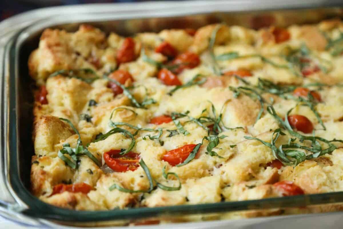 caprese bread pudding in a glass casserole dish.