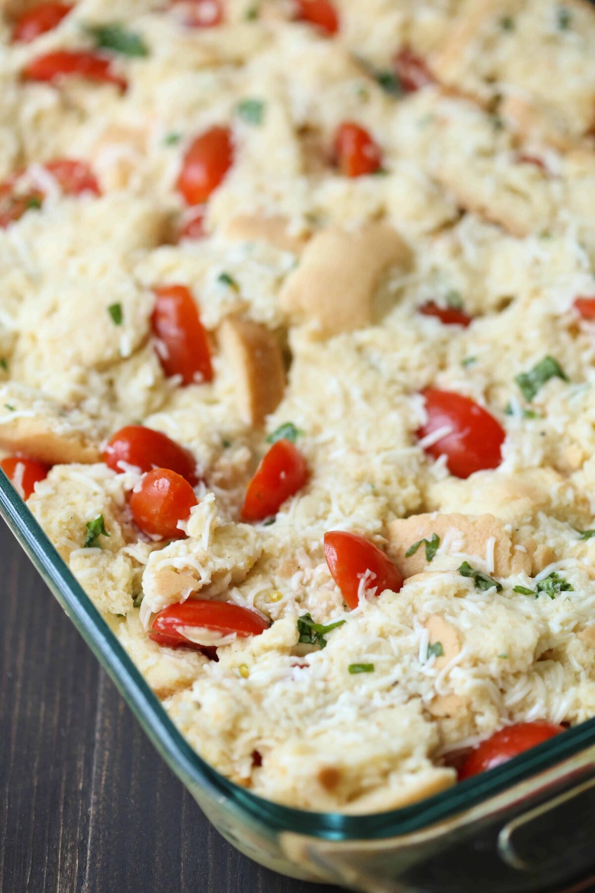 uncooked caprese bread pudding in a glass dish.