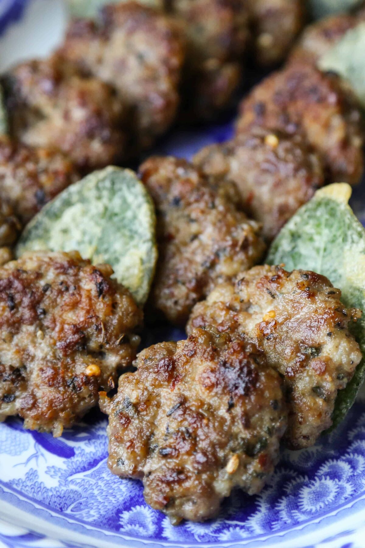 italian breakfast sausage patties on a blue platter.