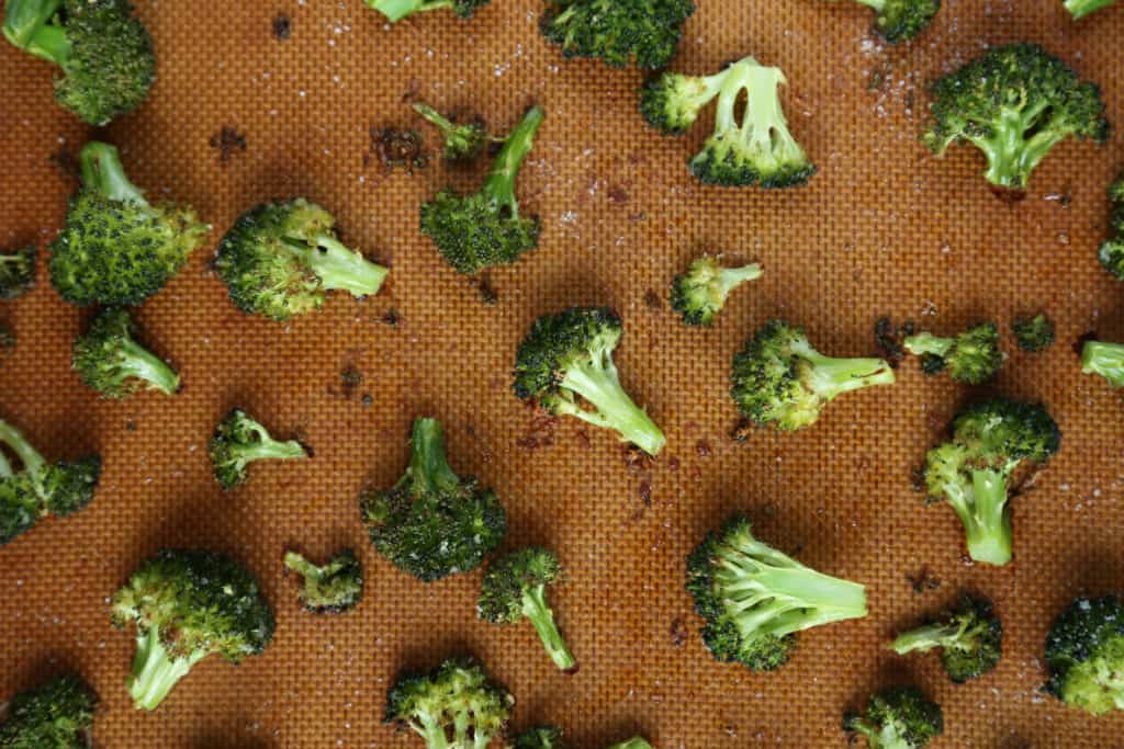 roasted broccoli on a baking sheet.