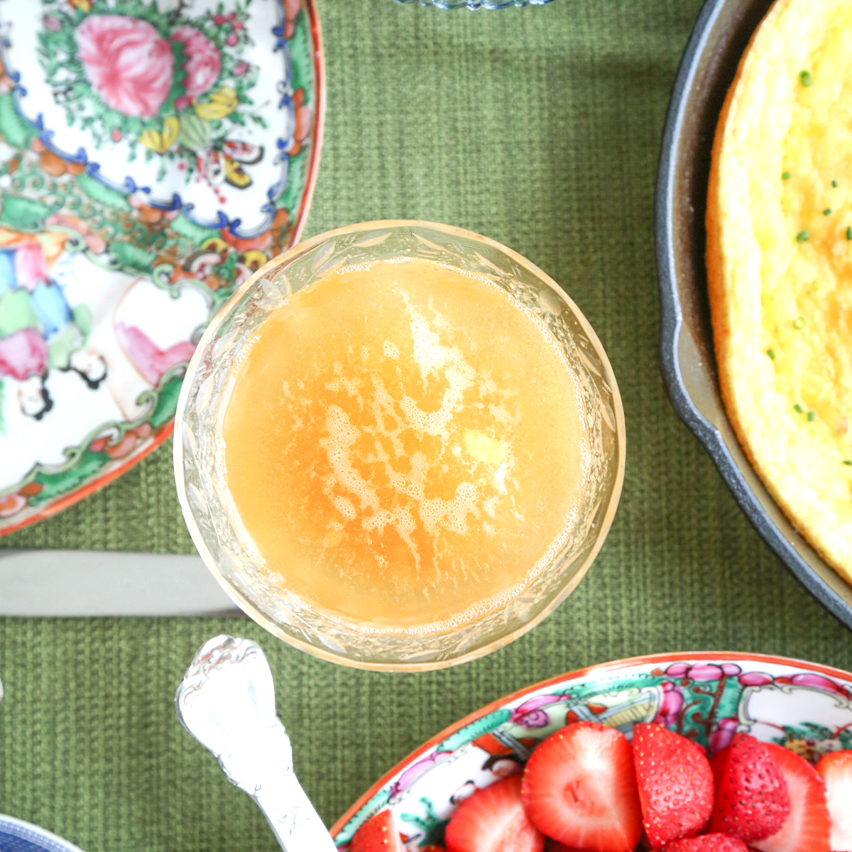 coupe of bellini on a green tablecloth