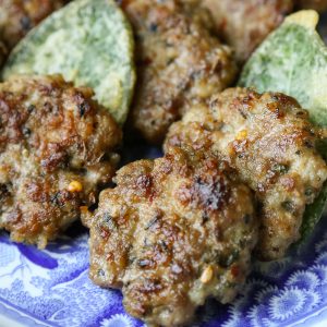 italian breakfast sausage patties on a blue and white platter.