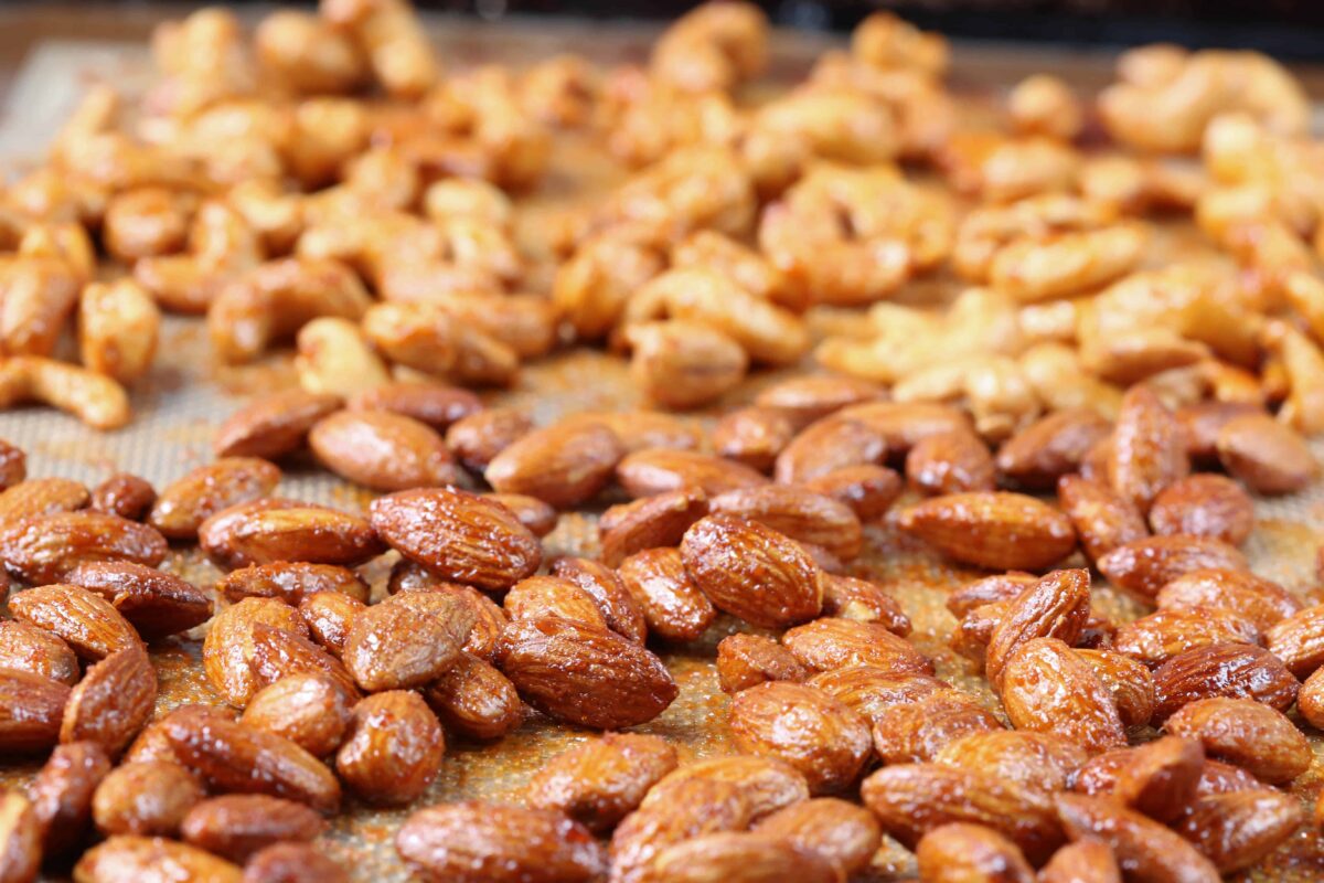 roasted almonds and cashews on a sheet pan.