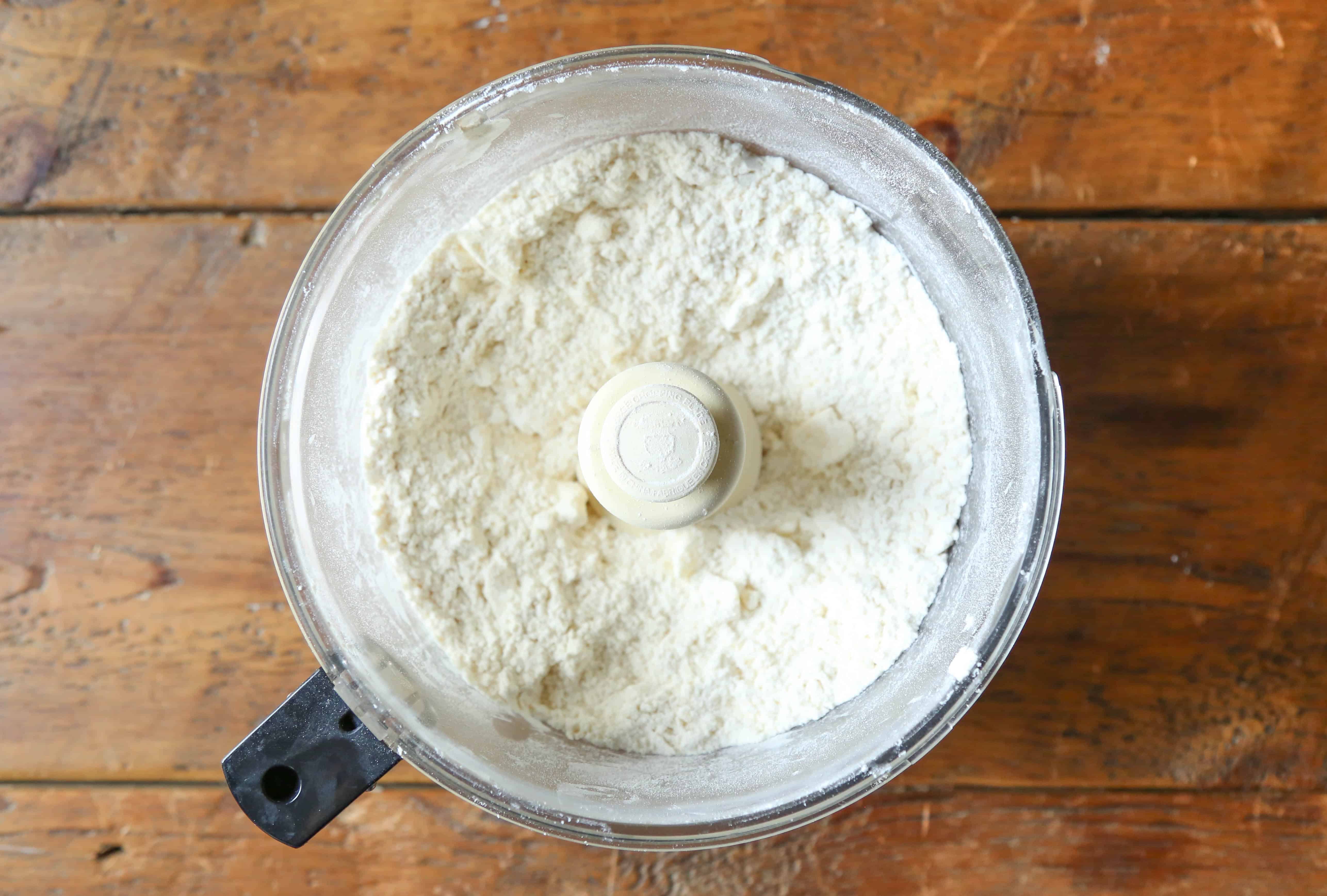 pie dough in the bowl of a food processor