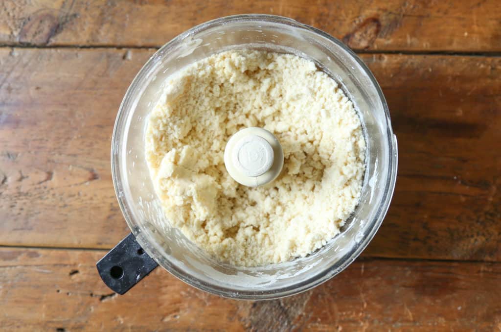 pie dough in the bowl of a food processor