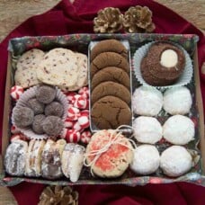 shallow box filled with an assortment of holiday cookies.