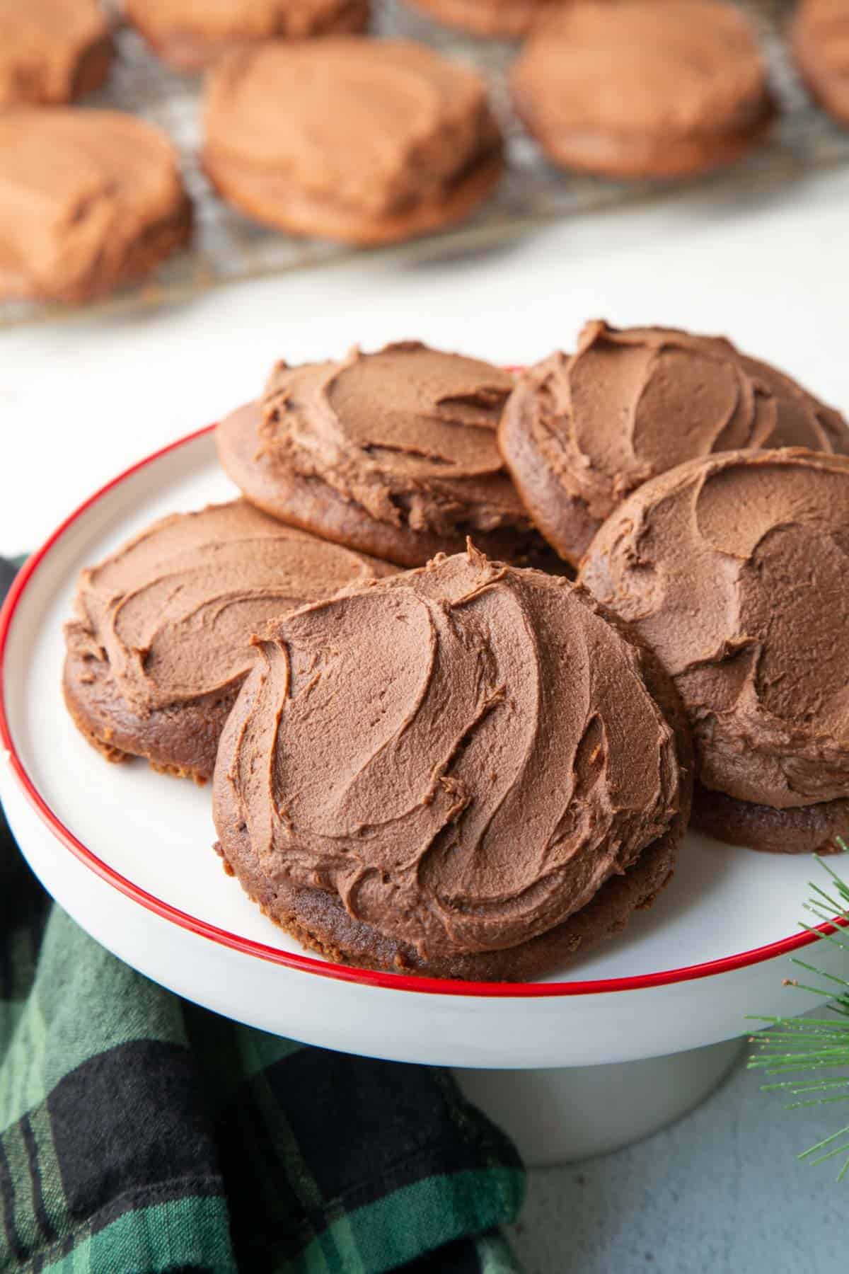 chocolate drop cookies on a white pedestal plate.