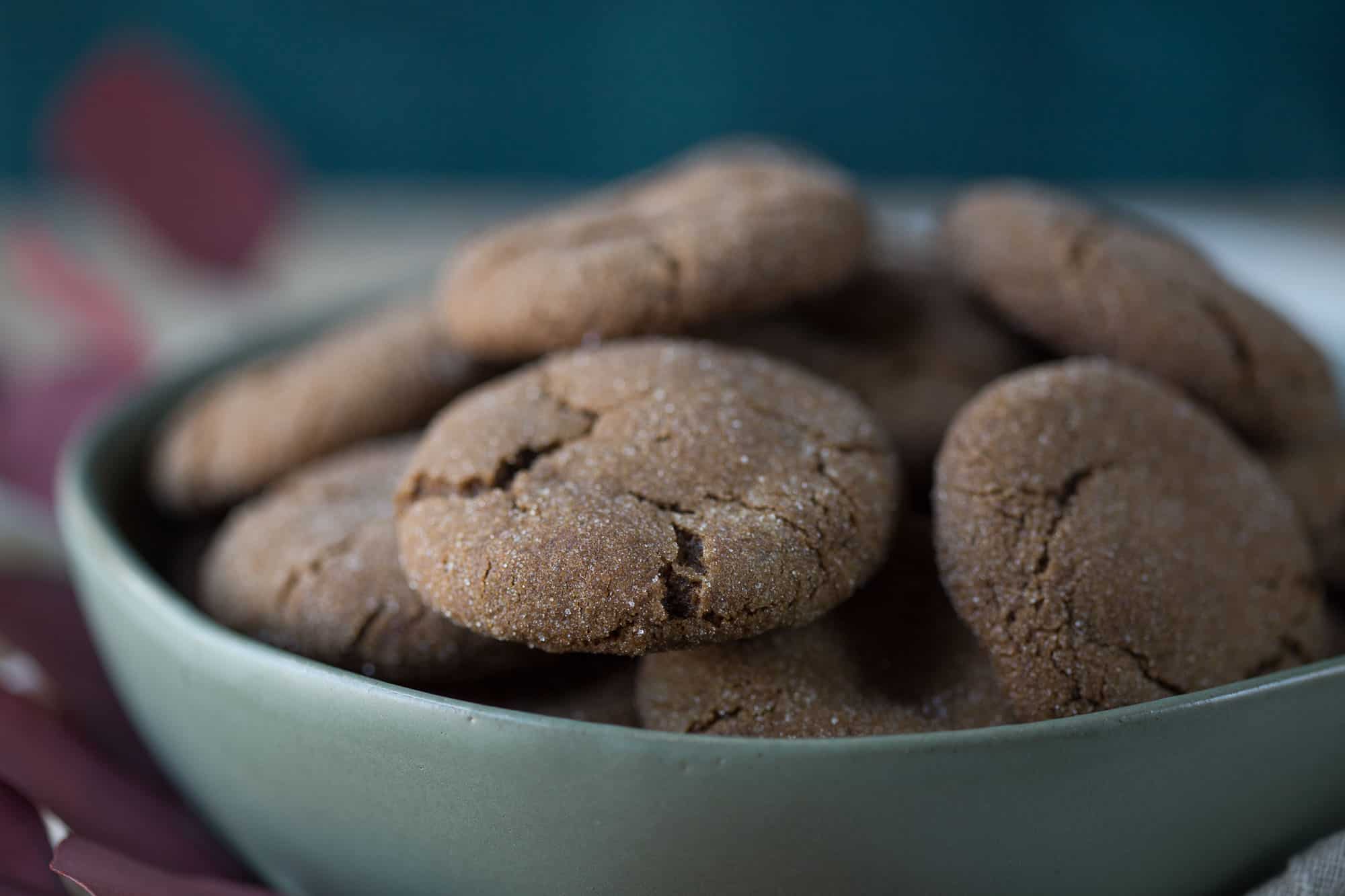 green bowl full of soft ginger cookies