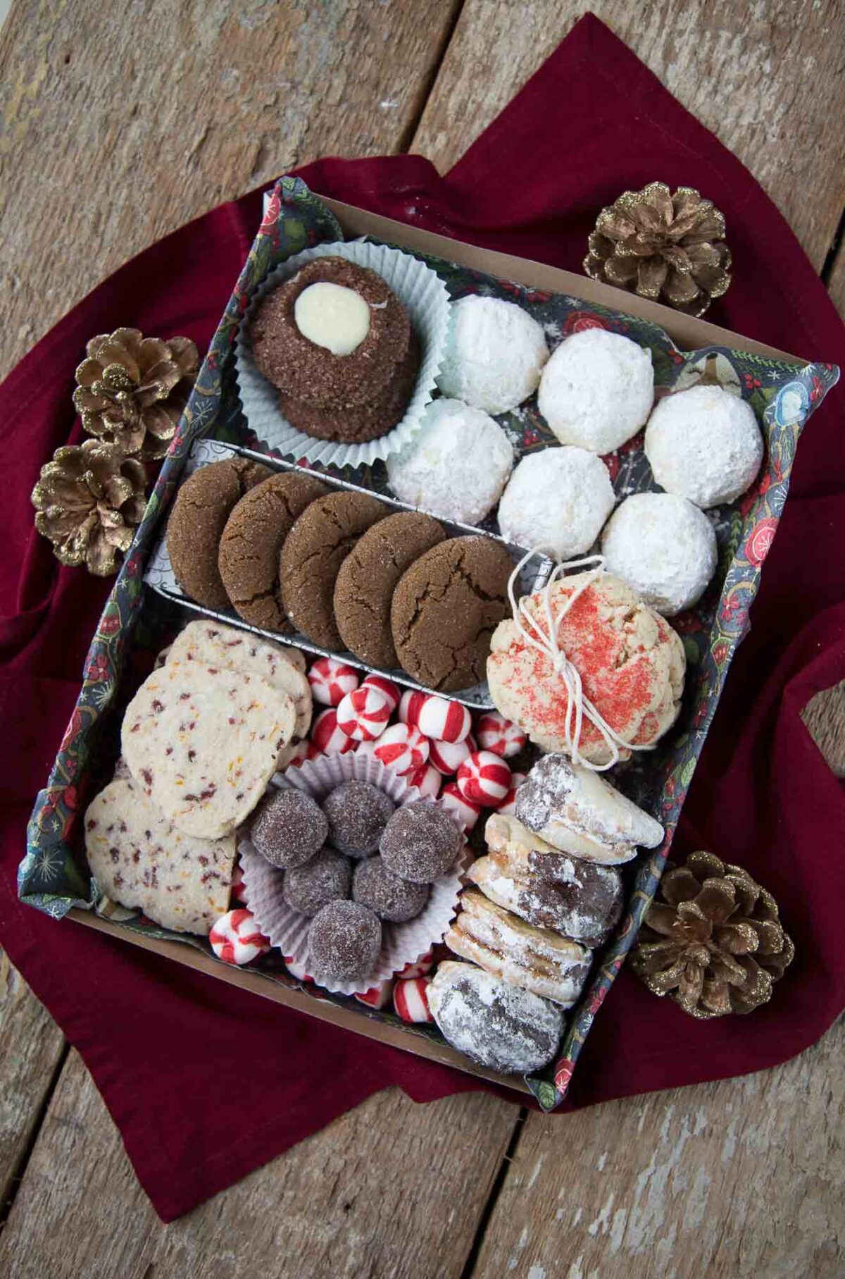 assorted of christmas cookies in a rectangular box.