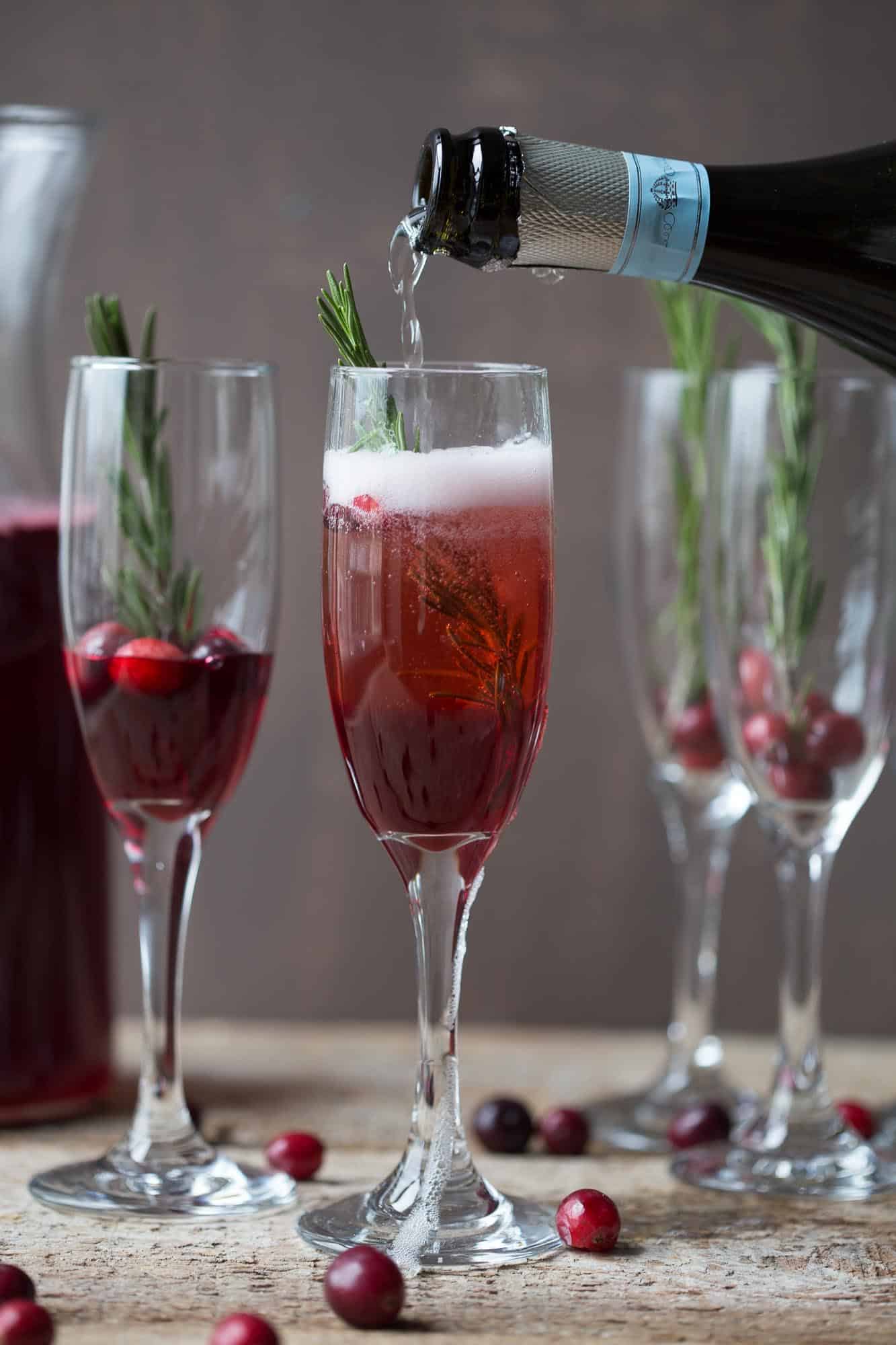 flutes filled with a cranberry prosecco cocktail.
