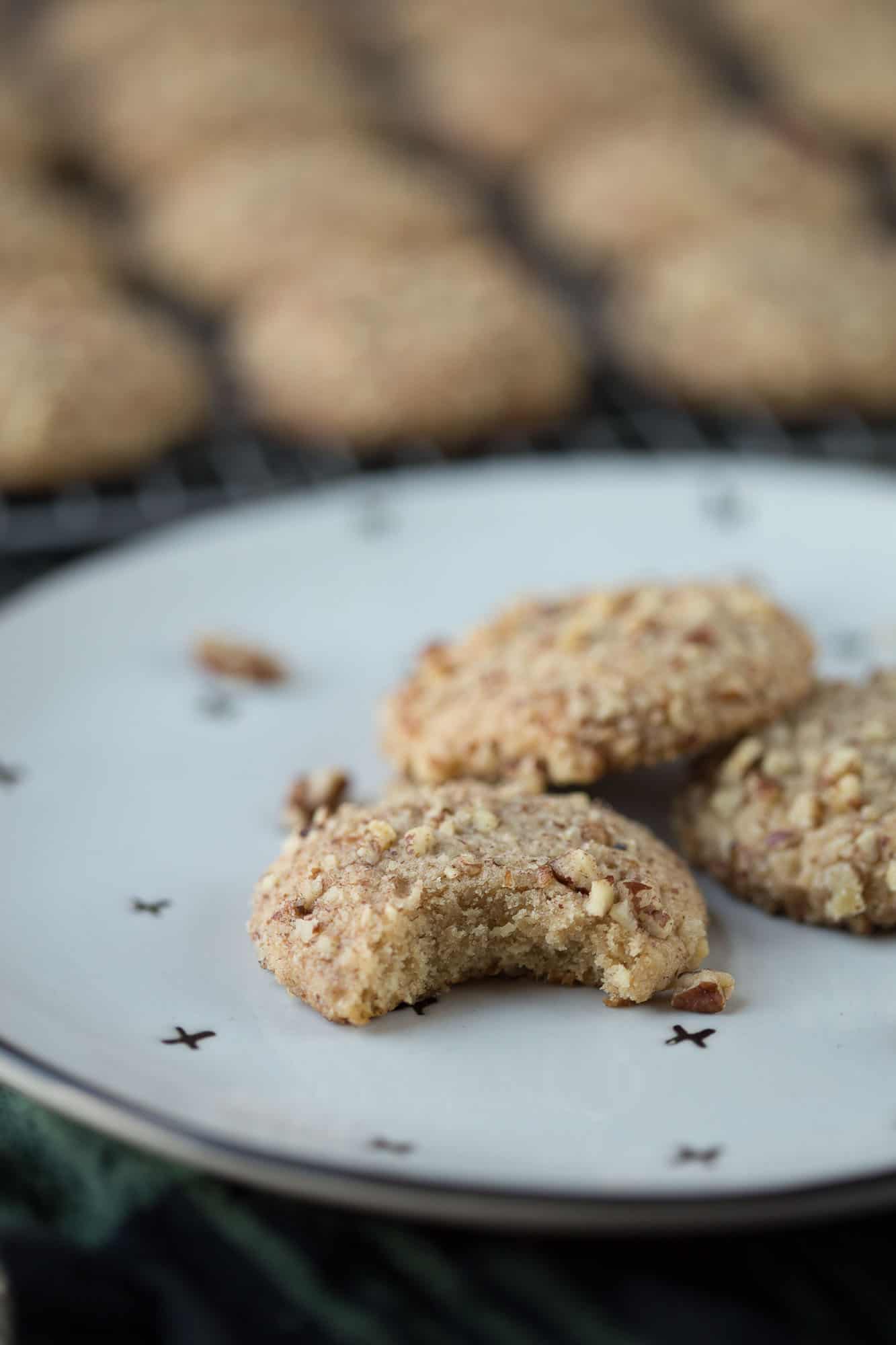 do re mi cookies on a white plate with a bite taken out of one.