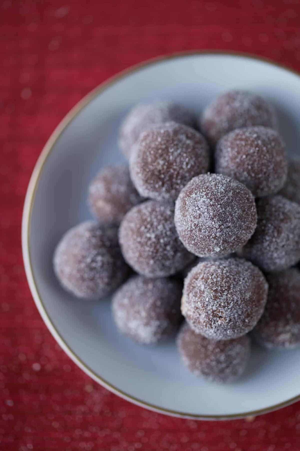 Grandma's Rum Balls in a white dish on a red tablecloth.