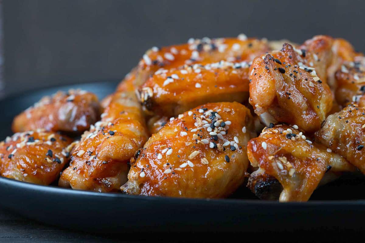 plate of sweet and spicy wings topped with everything bagel seasoning.