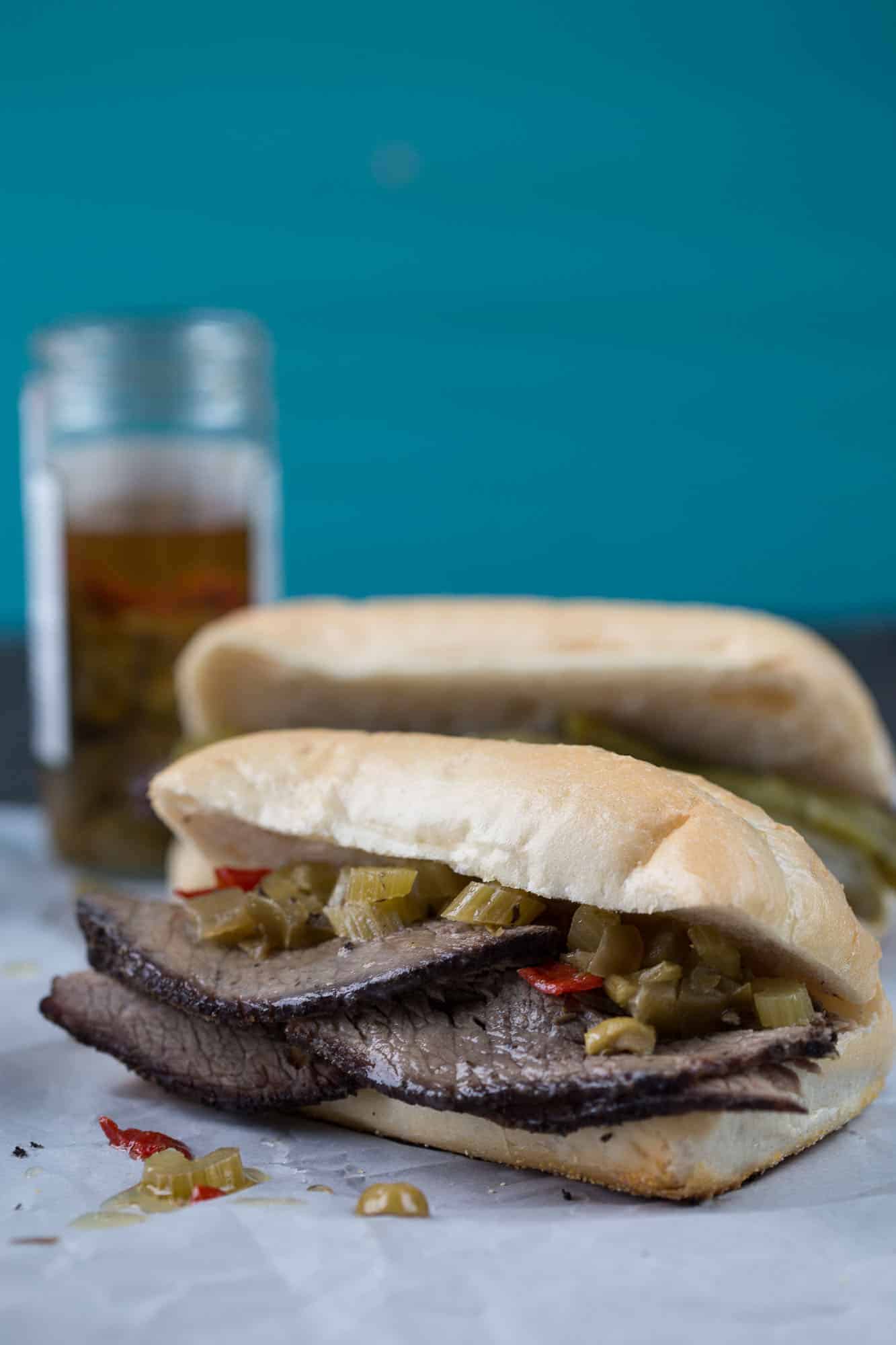 italian beef sandwich with giardiniera on white parchment paper