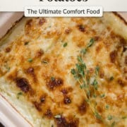 cheesy casserole with layers of potatoes and a cheesy top, topped with fresh thyme.