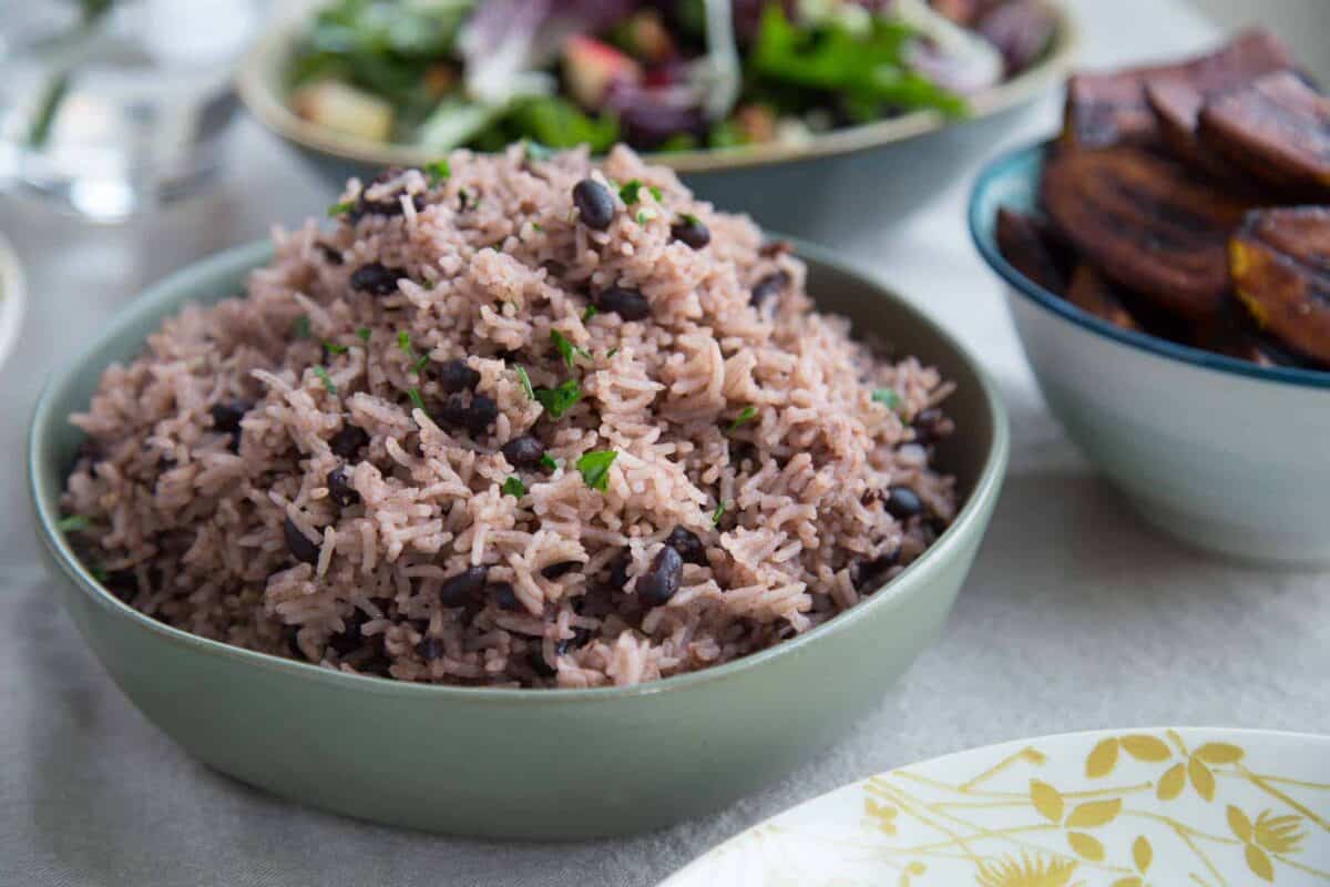 green bowl filled with arroz moro on a dinner table