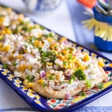 elote dip on a colorful rectangular platter.
