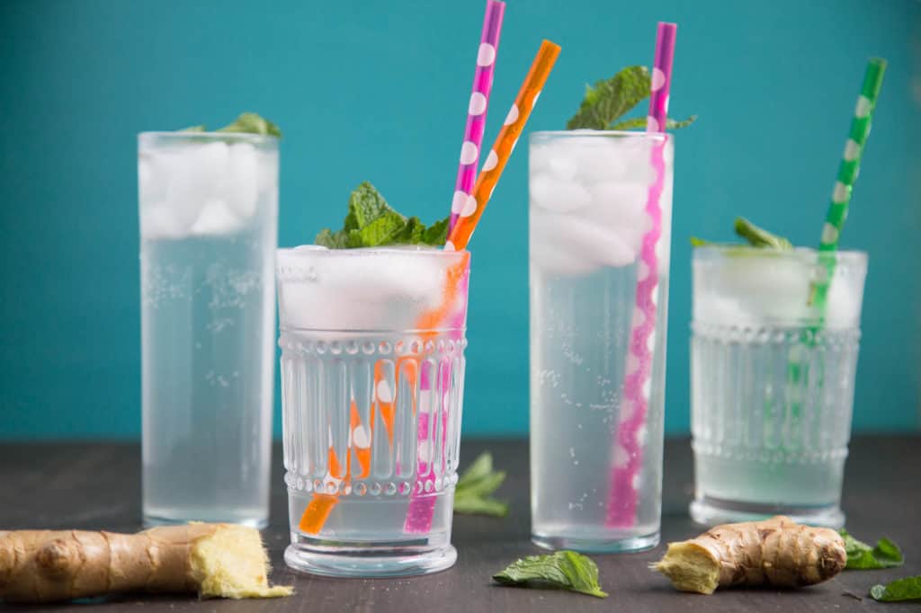 tall glasses of homemade ginger ale with colorful straws