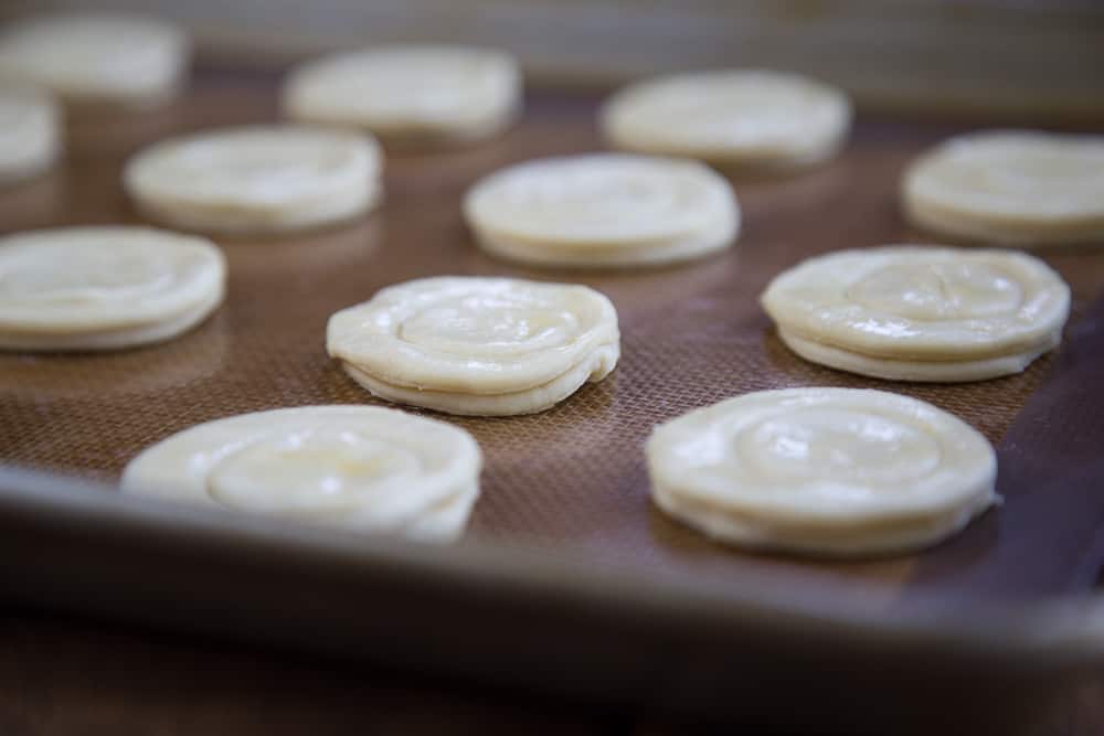 raw puff pastry cups on a sheet pan