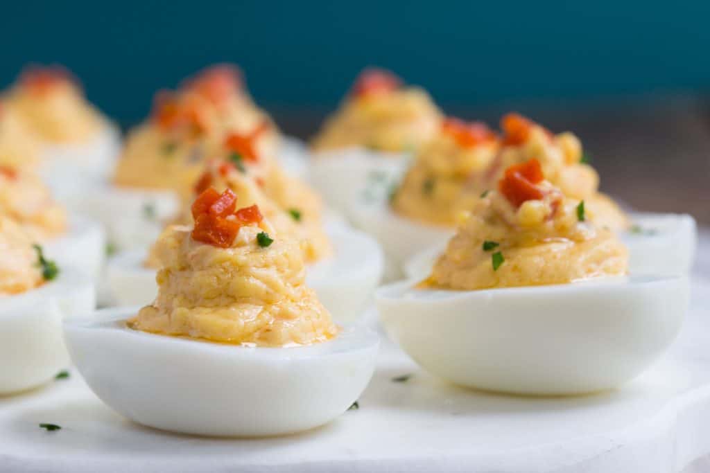 pimento cheese deviled eggs on a white platter