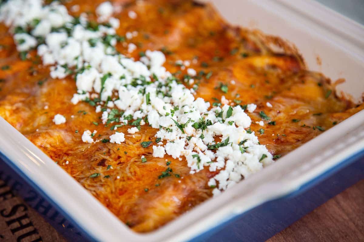 red enchiladas topped with queso fresco and cilantro.