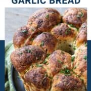 pull apart garlic bread topped with fresh chopped parsley.