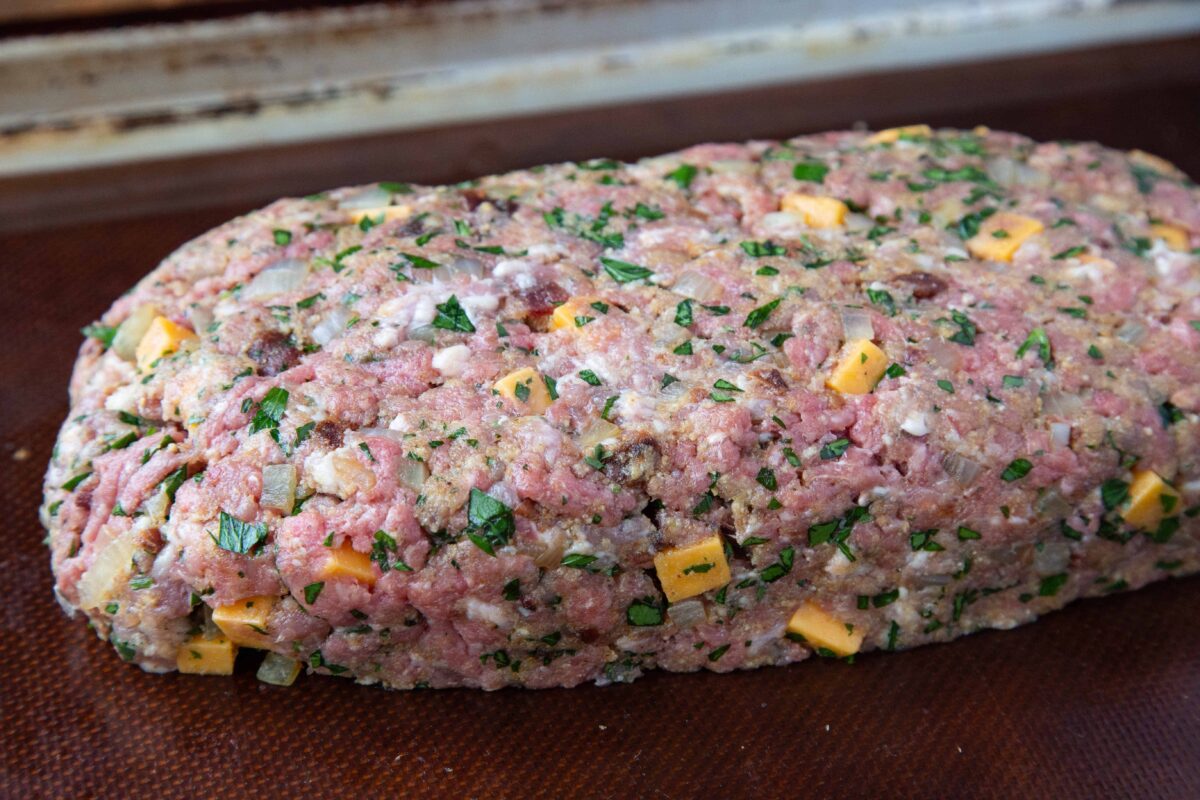 Uncooked meatloaf on a sheet pan