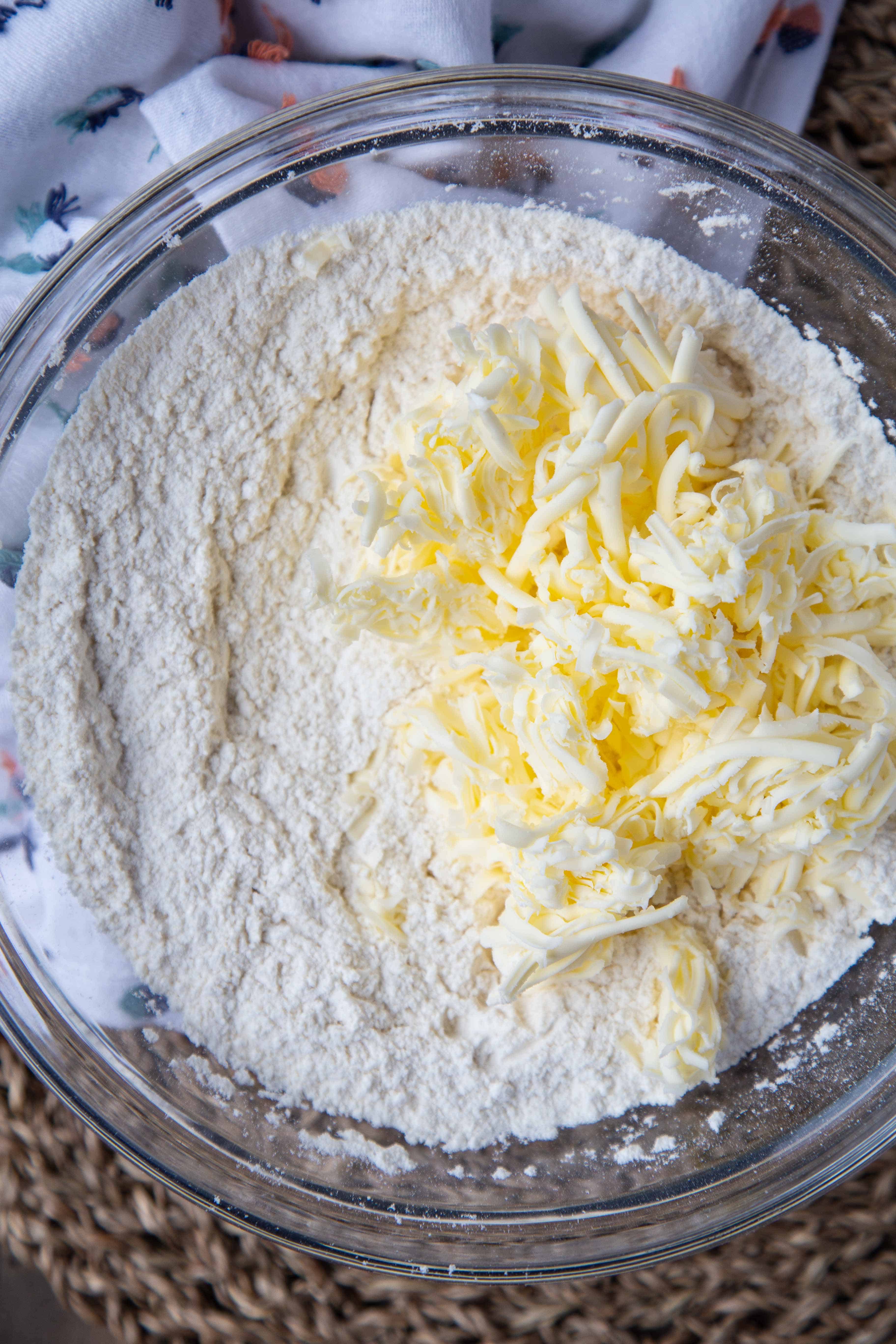 glass bowl with flour and grated butter