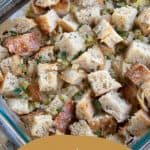 sourdough stuffing in a casserole dish on a thanksgiving table.