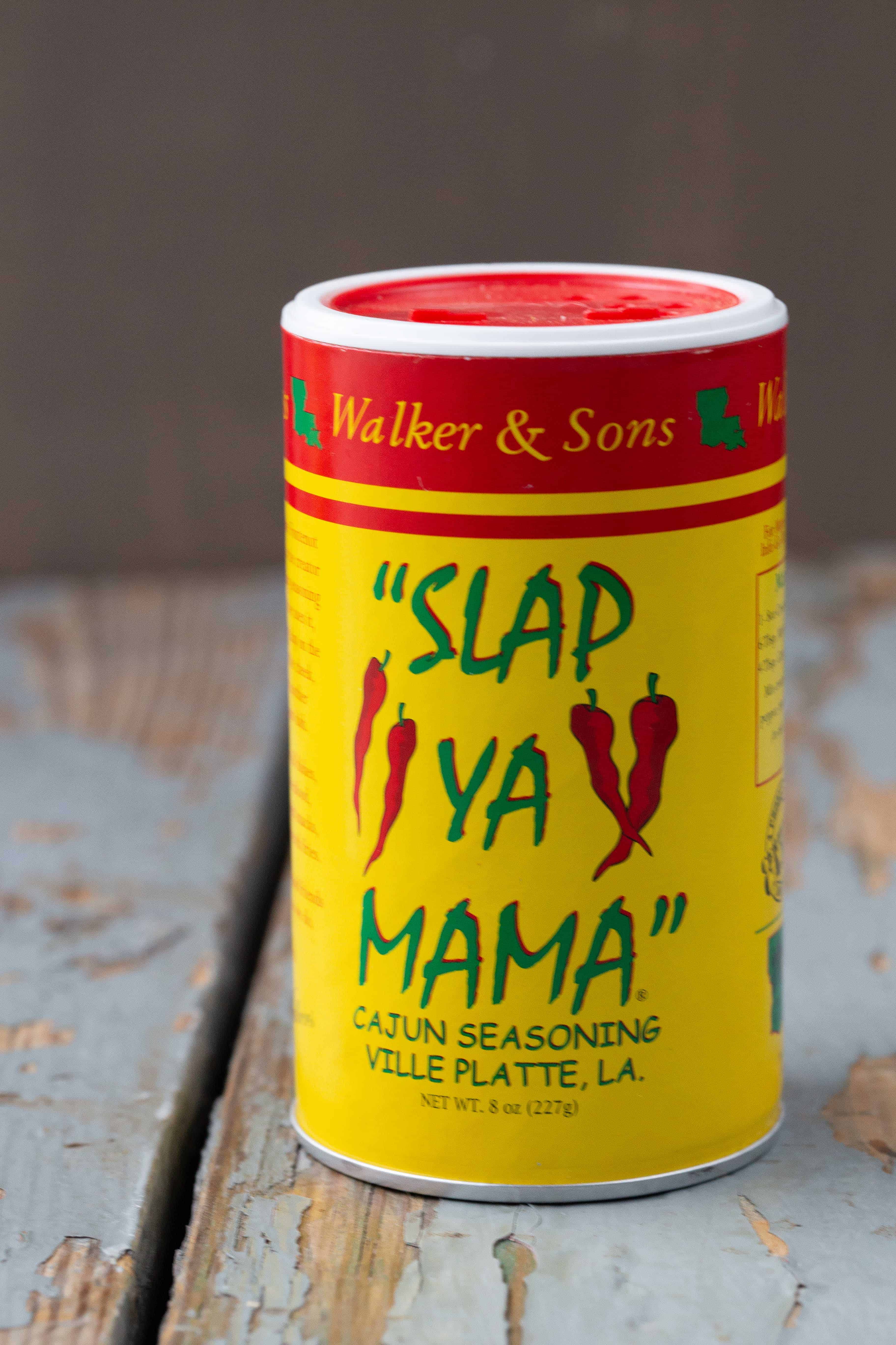 jar of Slap Ya Mama seasoning on a wooden table