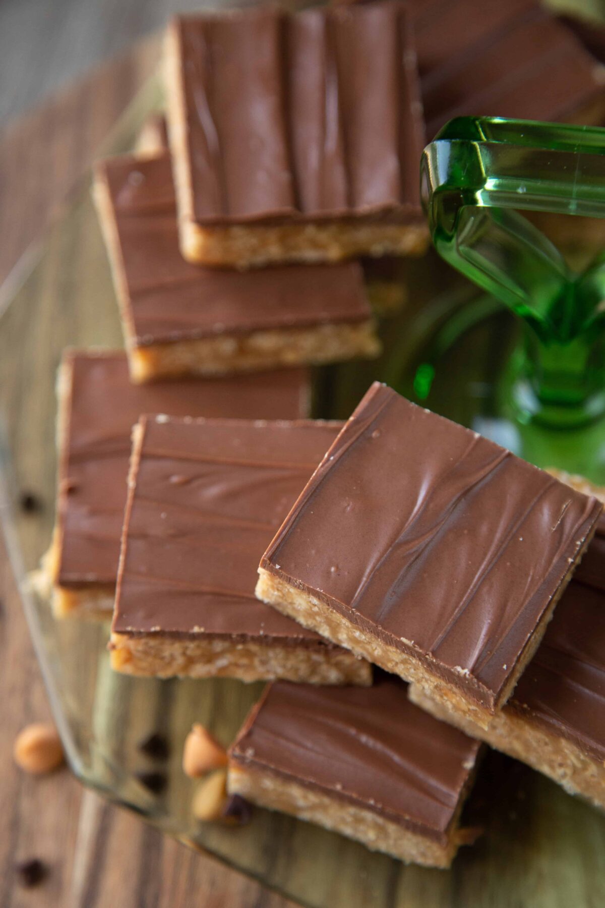 special k bars stacked on a green glass cookie platter.
