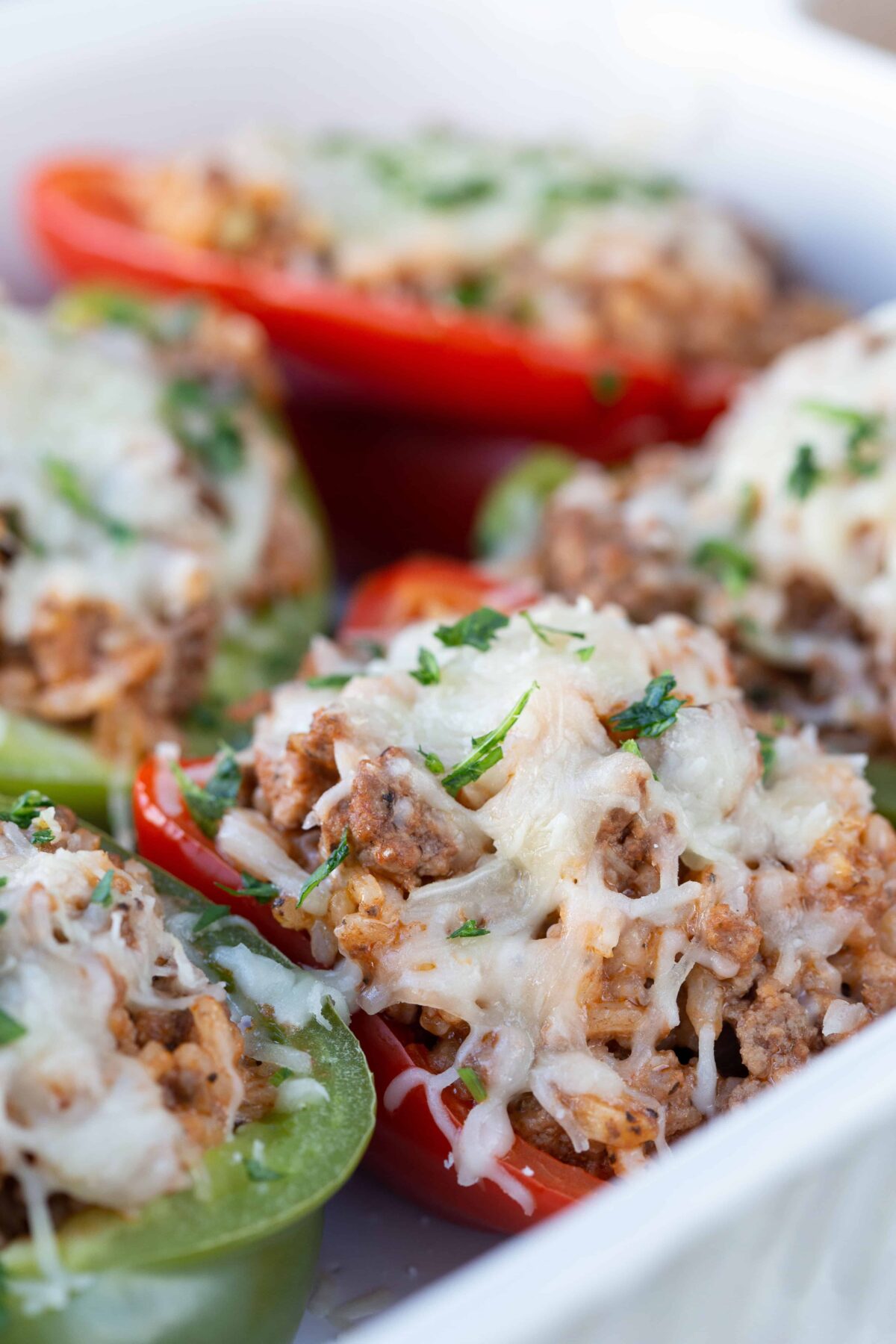 Italian Stuffed Peppers in a white casserole dish.