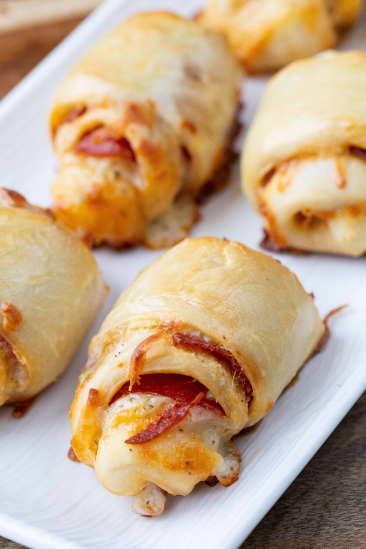 Easy Pepperoni Rolls with pizza dough on a white platter.