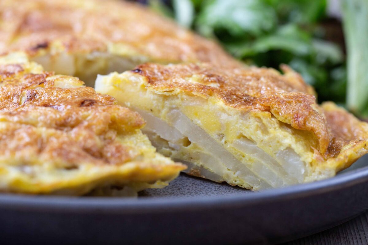 close up side view of slice of Spanish Potato Omelette.