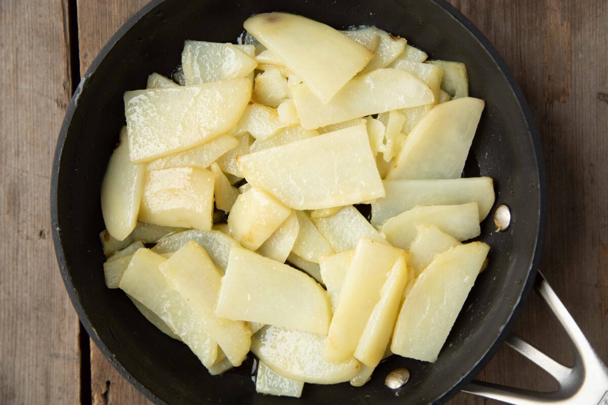 sliced potatoes in a skillet.