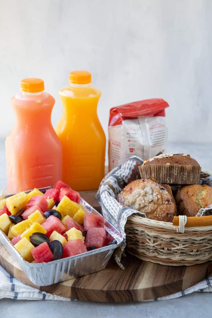 Breakfast basket with muffins, fruit, and juice