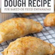 shiny crimped empanadas on a wire rack.