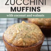 zucchini muffin with coconut and walnuts on a wire rack.