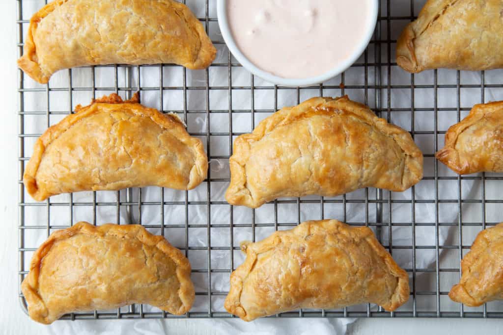 Chicken Enchilada Empanadas on a wire rack.