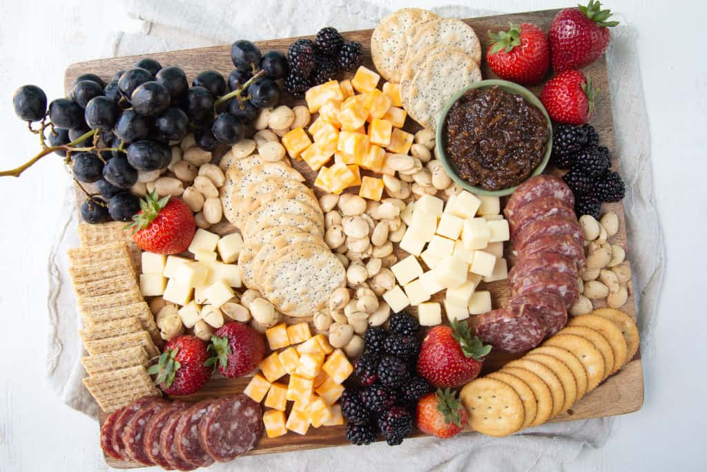 Overflowing cheese board on a wooden platter