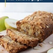 loaf of pear bread on a decorative wooden board.