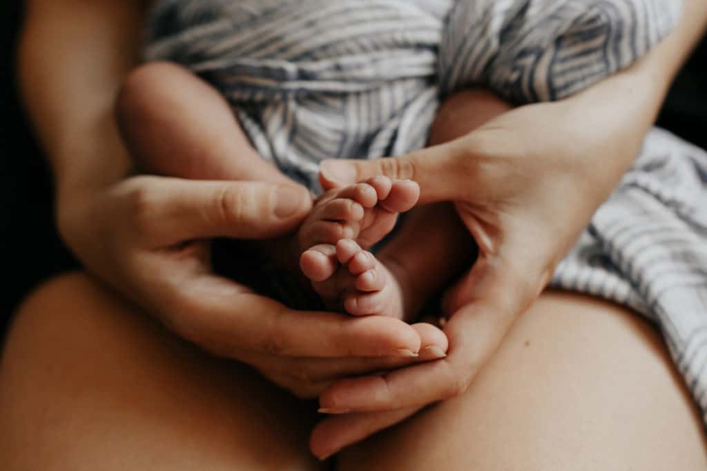 hands holding baby's feet