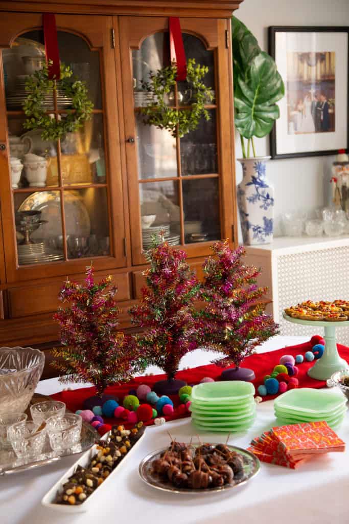 Christmas appetizer buffet with tinsel christmas trees.