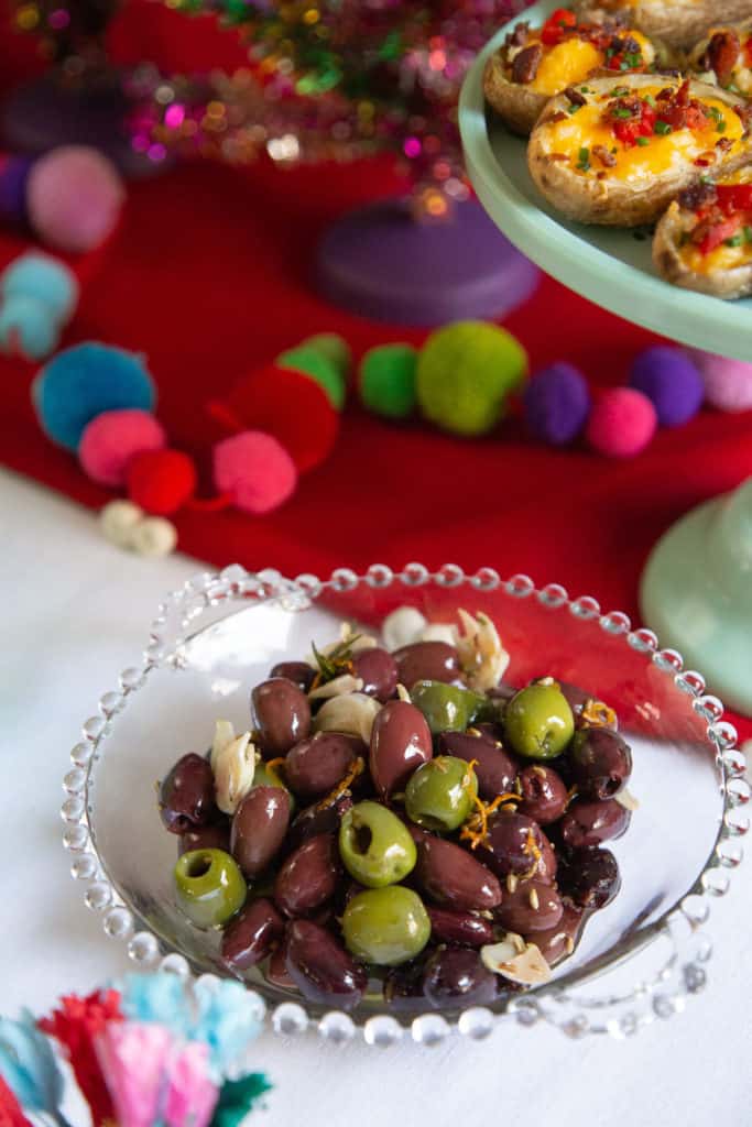 Citrus marinated olives in a glass dish.