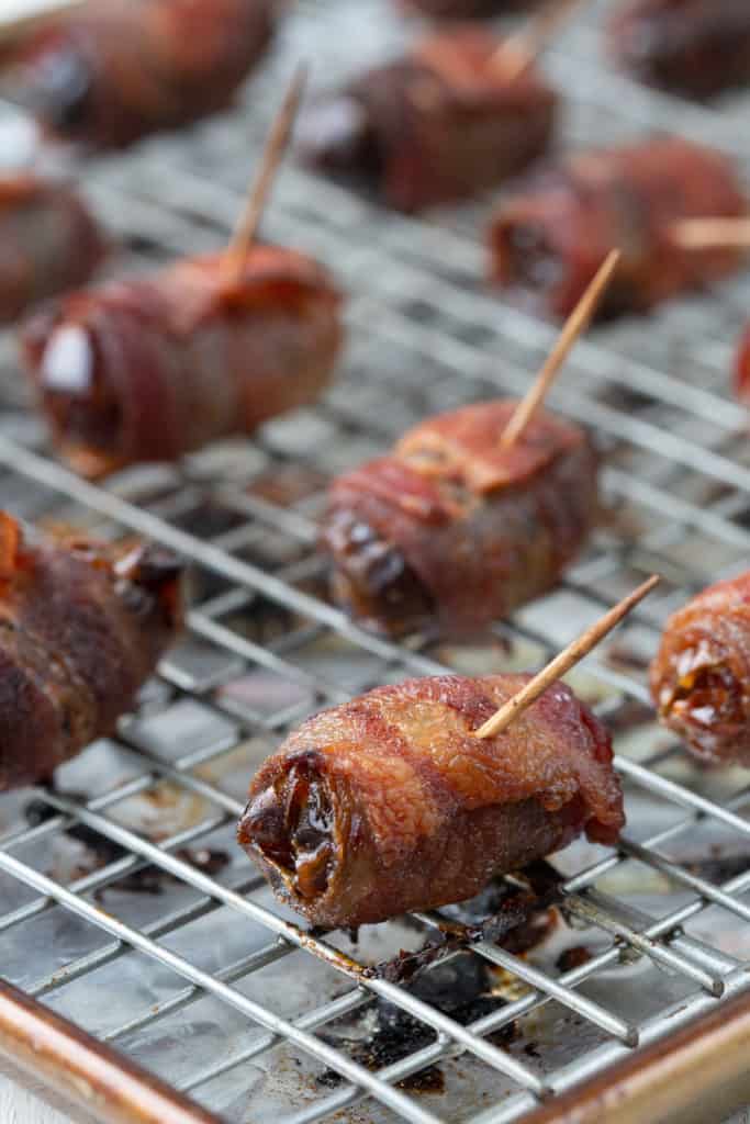 Boozy Bacon Wrapped Dates on a wire rack