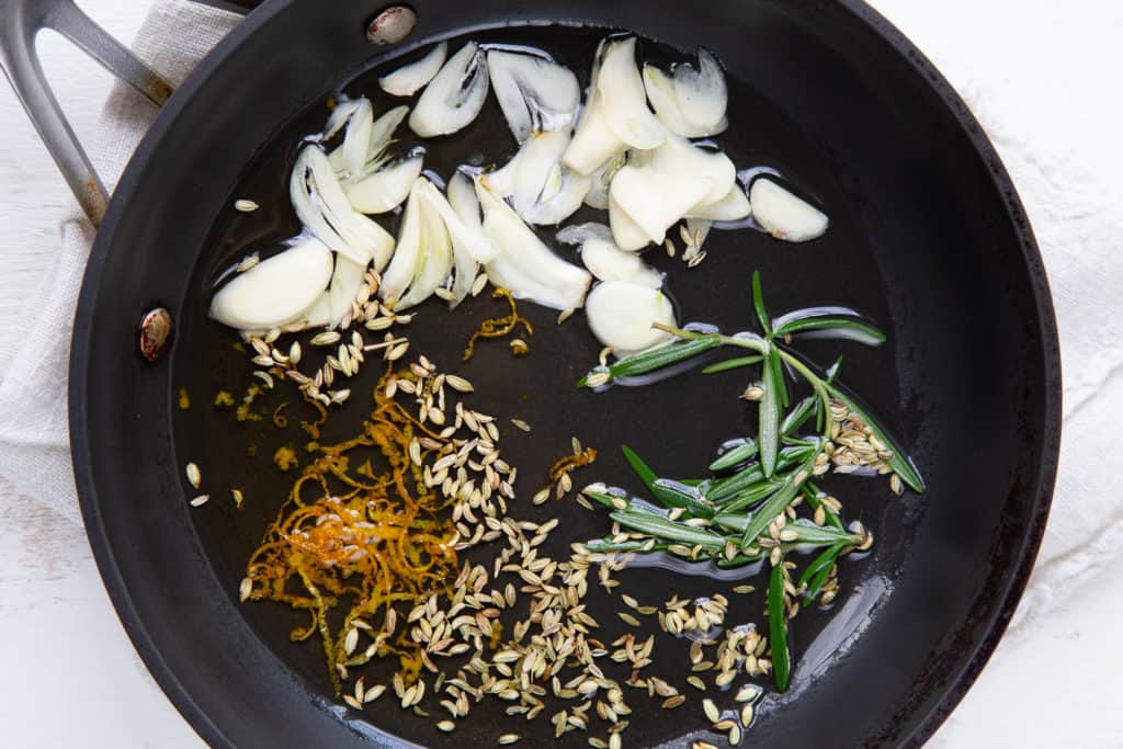Aromatics and olive oil in a sauté pan.