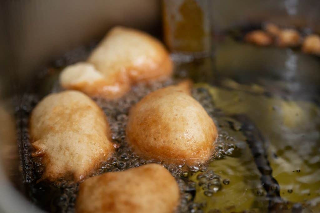 Beignets frying in hot oil