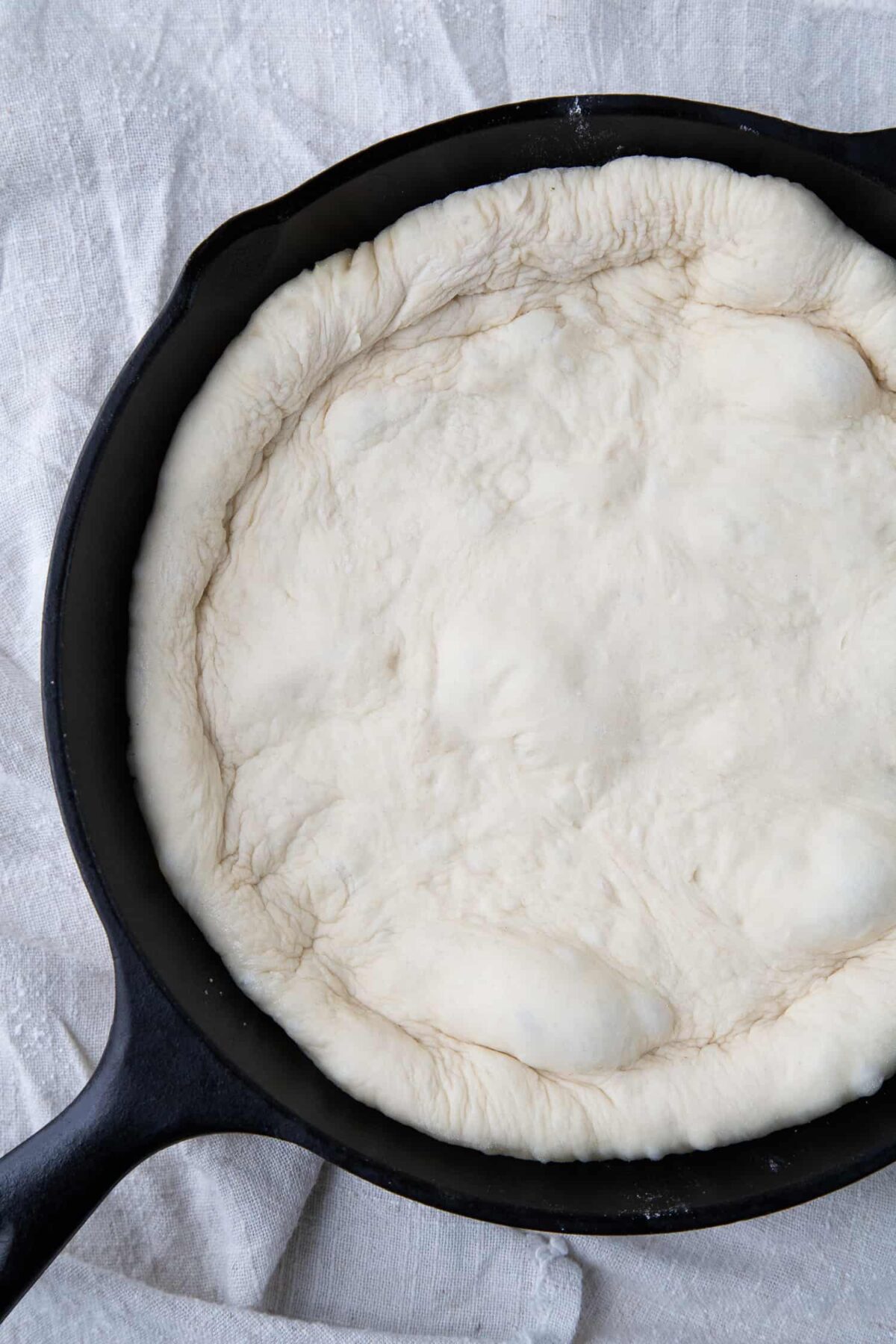 pizza dough in a cast iron pan